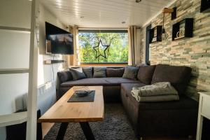 a living room with a couch and a table at Sea Side, Tiny House 13 in Salzhemmendorf