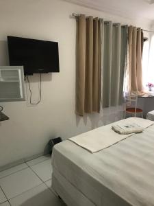 Postel nebo postele na pokoji v ubytování Lax Hotel - Acesso através de escadas - 3 andares