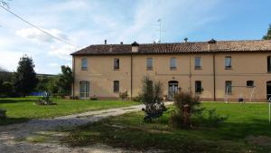 a large building with a grass yard in front of it at B&B La Palazza in Russi