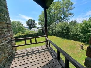 una veranda in legno con recinzione e campo di Gîte Filly 4A1 - 4 pers. a Nadrin