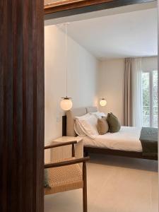 a bedroom with two beds and a mirror at Vireo Rooms in Santa Maria Navarrese