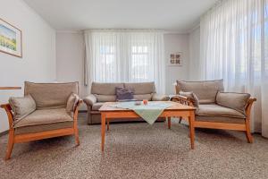 a living room with two couches and a coffee table at Villa Viktoria Whg 16 - "Auskuck" in Kölpinsee