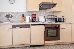 a kitchen with a stove and a counter top at Villa Viktoria Whg 16 - "Auskuck" in Kölpinsee +5 photos