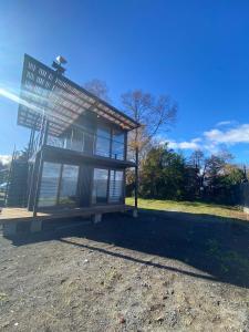 a building that is sitting on top of a field at Cabaña 1 Lican Ray primera linea in Licán Ray