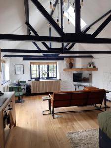 a living room with a couch and a table at The Studio, Arundel in Arundel +2 photos
