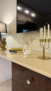 a counter top with candles and a lamp on it at Grace Boutique Hotel in Islamabad +96 photos