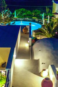 a view of a swimming pool at night at Kalimera Hotel in Akrotiri