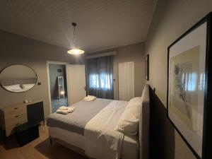 a hotel room with a bed and a mirror at Kariofilli's house in Áyios Athanásios