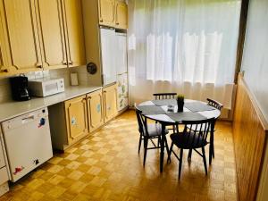 a kitchen with a table and chairs and a refrigerator at Апартаменты в Иматре in Imatra