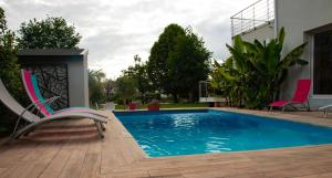 a swimming pool with a chair next to a house at Bords de Sarthe in Le Mans