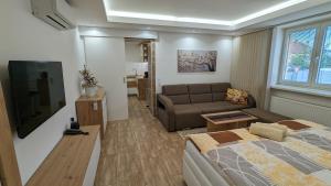 salon z łóżkiem i kanapą w obiekcie Apartmán Štěpánka w mieście Ratíškovice