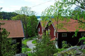 a group of houses with red roofs at Grinda Wärdshus in Grinda