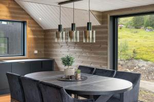 a dining room with a table and chairs at Mountain View Apartment - penthouse in Stranda +17 photos