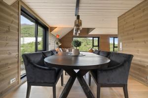 a dining room with a circular table and chairs at Mountain View Apartment - penthouse in Stranda