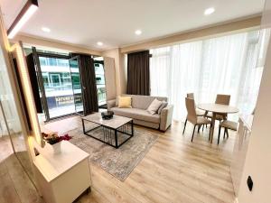 a living room with a couch and a table at Luxury apartment in Batumi view with sea view in Batumi