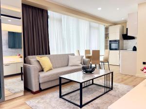 a living room with a couch and a table at Luxury apartment in Batumi view with sea view in Batumi