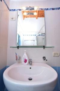 a bathroom with a white sink and a mirror at Countryside house in Vlorë