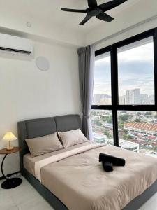 a bedroom with a bed with a ceiling fan at URBAN Georgetown 9Pax 4QueenBed 3Bedroom 2Bath 2carparks in Jelutong +79 photos