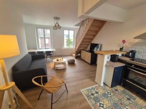 a living room with a couch and a table at Maison Les 4 Mers in Eu +26 photos