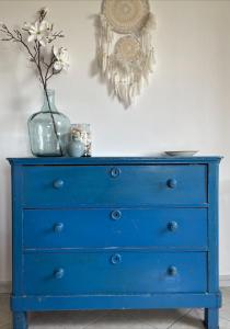 a blue dresser with a vase on top of it at B&B La Vera Vita in Troviggiano