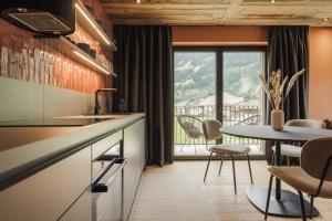 a kitchen with a table and a dining room at Zellrooms in Zell am Ziller +54 photos