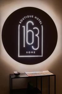 a black and white sign on a wall at 163 BOUTIQUE HOTEL in Rome