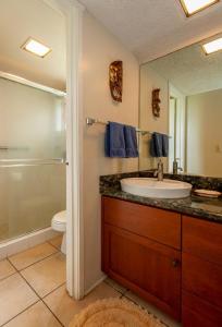 a bathroom with a sink and a shower and a toilet at Sealodge F1 in Princeville