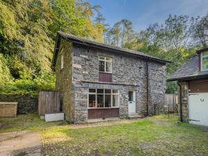 a stone house with a garage in the yard at 3 Bed in Water Yeat SZ079 in High Nibthwaite
