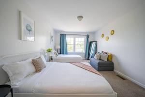 een slaapkamer met een groot wit bed en een bank bij Central 3BR 2BA Near Beach Hard Rock Ocean in Atlantic City +32 foto's