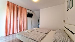 a bedroom with two beds and a window at Cozy room Peny in Karlovac