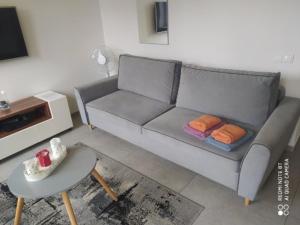 a living room with a couch and a table at Studio Świętojańska in Gdynia +5 photos
