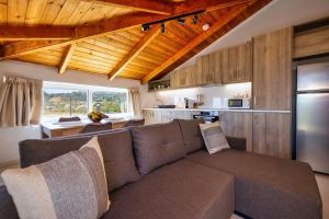 a living room with a couch and a kitchen at Ionian Serenity House in Zakynthos