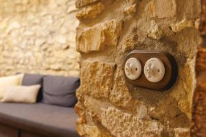 a wall with two plugs in a stone wall at Bravissimo Girona 1593, Medieval charm in Girona
