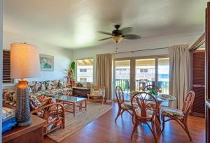a living room with a couch and a table and chairs at Hanalei Colony Resort J3 in Hanalei