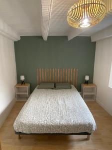 a bedroom with a large bed with two night stands at Appartement Florette in Besse-et-Saint-Anastaise