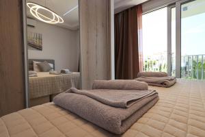 a bedroom with two beds and a mirror at Silver Sea Holiday Apartments in Ayia Napa +56 photos
