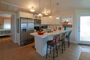 a kitchen with a large island with bar stools at Plantation at Princeville 1322 in Princeville