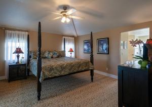 a bedroom with a bed with a ceiling fan at Plantation at Princeville 1322 in Princeville
