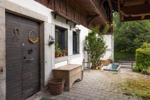 a porch with a wooden bench next to a door at Magnifique Chalet aux Carroz in Arâches-la-Frasse +18 photos