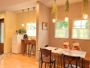 a kitchen with a table and chairs in a room at Opopo home 竜宮店 in Otaru