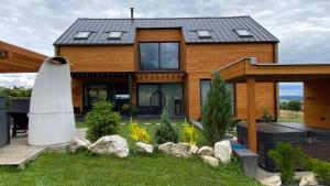 a house with a surfboard in front of it at Chalet Sijkovsky in Stará Lesná