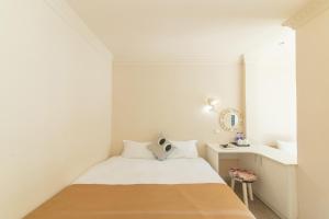 Postel nebo postele na pokoji v ubytování 厦门鼓浪屿湾景酒店