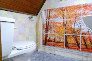 a bathroom with a toilet and a window with trees at Light house hongdae Open sale in Seoul +55 photos