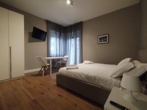 a hotel room with a bed and a table with chairs at HH Hermoso Housing VIA PAIETTA in Valenza