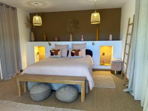 a bedroom with a large white bed with a table at Chambre d'hôtes A Vadina Porticcio in Porticcio