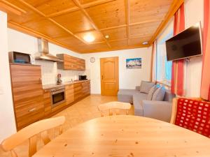 a kitchen and a living room with a table and a couch at Beim Talschuster in Scheffau am Wilden Kaiser +33 photos
