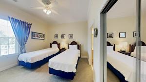 a bedroom with two beds and a window at Coastal Escape at Greenhaven Inviting 4BR3BA Condo in Pawleys Island