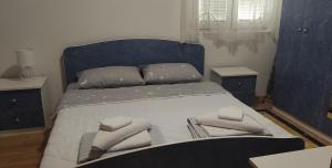 a bedroom with a bed with two pillows on it at Šumska Vila in Bajina Bašta