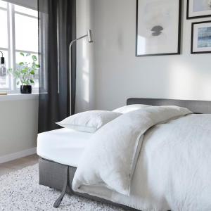 a white bedroom with a bed with white sheets and pillows at LUX Flat Marylebone in London