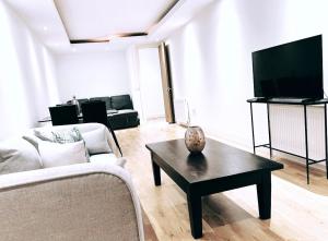 a living room with a couch and a coffee table at LUX Flat Marylebone in London